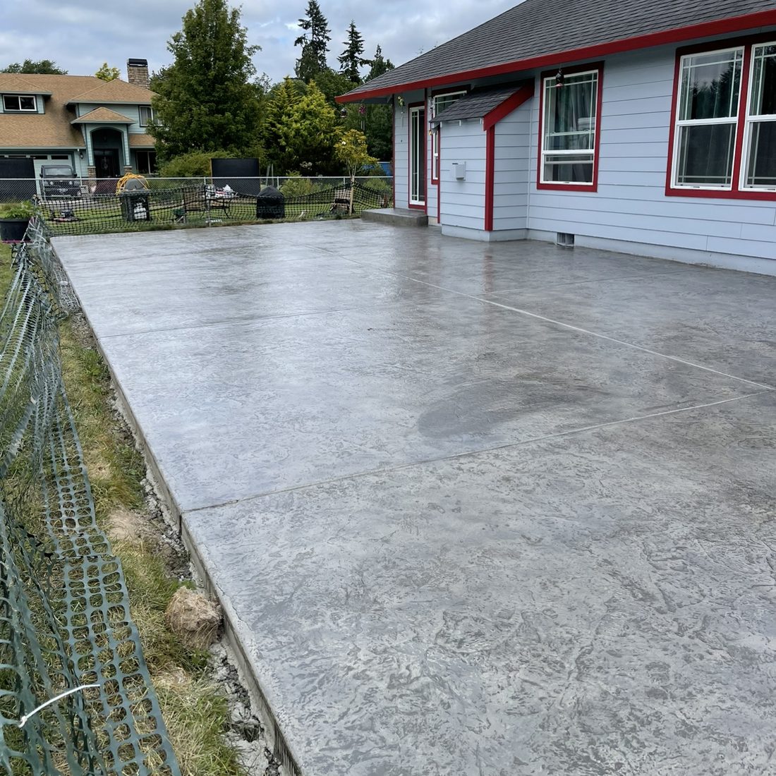 Large broom-finish concrete patio, completed project by Rocky Ridge Concrete